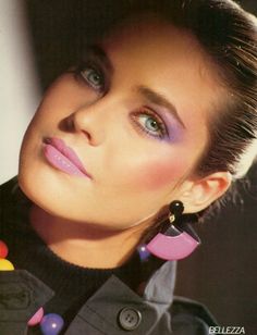 a woman with blue eyes and pink lipstick is posing for a magazine cover or advertisement