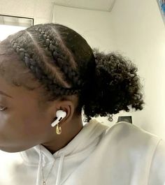 a woman wearing ear buds in her hair