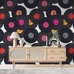 a record wallpaper with pink, orange and yellow discs on it in a living room