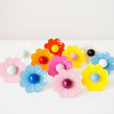 colorful plastic flowers on a white surface