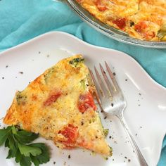 a slice of quiche on a white plate with a fork next to the pie