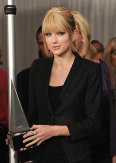 taylor swift is holding an award for her performance in the music video