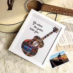 a guitar and some music sheets on a white blanket with an image of someone playing the guitar