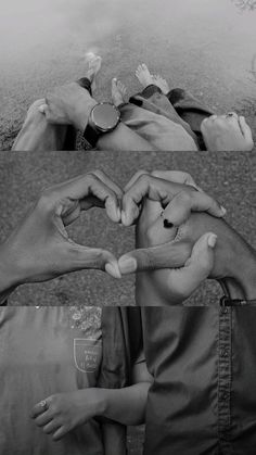 black and white photograph of two hands making a heart with their fingers on the ground