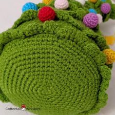 green crocheted bag with colorful buttons on it