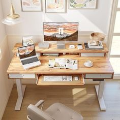 a desk with two laptops and a chair in front of it on top of a hard wood floor