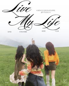 three young women walking across a lush green field with the words live my life written on it