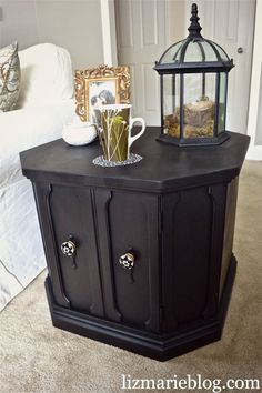 a black cabinet with two drawers and a coffee cup on top