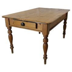 an old wooden table with one drawer on the top and two legs at the bottom