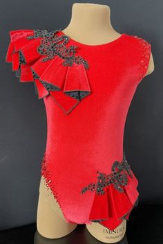 a mannequin wearing a red leotard with black sequins on it