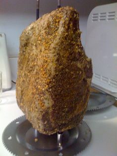 a large piece of bread sitting on top of a table next to a toaster