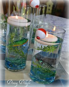 two vases filled with water and candles on top of a table