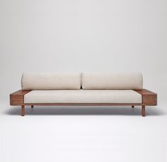 a white couch sitting on top of a wooden frame