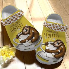 a pair of shoes with an image of a sloth drinking coffee