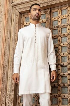 White kurta with pearl embroidery in abstract vertical lines. Paired with a pant. - Aza Fashions White Straight Kurta With Pearl Embroidery, White Elegant Kurta With Traditional Fit, Elegant White Kurta With Traditional Fit, Festive Fitted Kurta With Pearl Embroidery, Transitional Festive Kurta With Pearl Embroidery, Traditional Drape Kurta With Pearl Embroidery For Diwali, Elegant Cotton Kurta For Wedding, Elegant White Cotton Sherwani, Straight Kurta With Pearl Embroidery For Eid