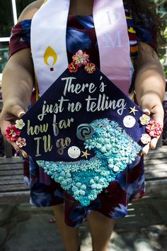 a woman holding a graduation cap that says, there's just no telling how far i go