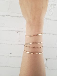 * This elegant bracelet has a bit of a playful attitude. Hand formed into a gentle wave shape and hammered for a faceted texture that reflects the light beautifully! * Lightweight and comfortable, with an easy to use latch clasp. * Made from top quality 14K gold fill (rolled gold) so it won't tarnish or turn like plated materials. Wear 24/7. Excellent for sensitive skin! * Lead and nickel free. * Comes packaged in a gift box. * When ordering- choose the length that matches the actual measurement Simple 14k Rose Gold-filled Bracelets, Simple Rose Gold 14k Gold-filled Bracelets, Simple Hammered Rose Gold Jewelry, Everyday Hammered Bangle Bracelets, Everyday Hammered Bangle Bracelet, Minimalist 14k Rose Gold Filled Bracelets, Minimalist Rose Gold 14k Gold-filled Bracelets, Stackable Rose Gold Bangle Chain Bracelet, Stackable Rose Gold Bangle Bracelet