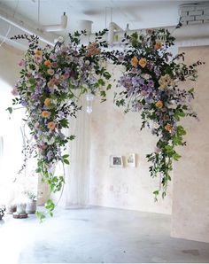 an arrangement of flowers hanging from the ceiling