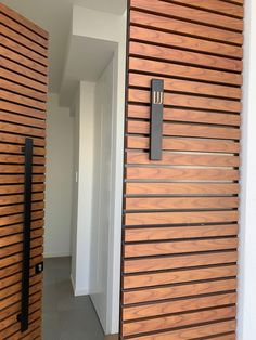 the door is made out of wooden slats and has a black handle on it