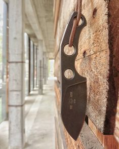 a knife hanging on the side of a building