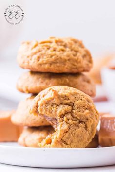 peanut butter cookies stacked on top of each other in a white bowl with caramel chunks