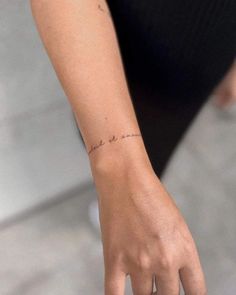 a woman's hand with a small tattoo on her left wrist that reads, i love you to the moon and back