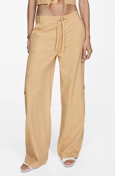 With smooth and drapey fabric and a drawstring waist, these trouser-inspired wide-leg pants are the perfect blend of casual and elevated. Zip fly with button closure; drawstring waist Front slant pockets; back welt pockets; side patch pockets 64% lyocell, 20% linen, 16% cotton Machine wash, line dry Imported Relaxed Wide Leg Parachute Pants For Spring, Versatile Wide Leg Pants With Drawstring, Spring Wide Leg Parachute Pants, Cotton Cargo Pants For Vacation, Wide Leg Bottoms With Cargo Pockets For Vacation, Casual Wide Leg Pants With Tie Waist, Casual Wide-leg Pants With Tie Waist, Relaxed Fit Wide Leg Parachute Pants For Vacation, Summer Wide Leg Cargo Pants With Drawstring