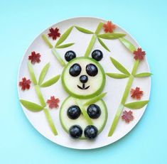 a plate that has some fruit in the shape of a panda bear on top of it