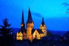 an old church lit up in the evening