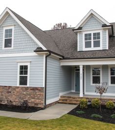 a blue house with white trim and windows