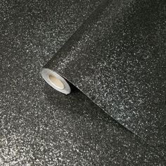 a roll of black glitter paper on top of a table