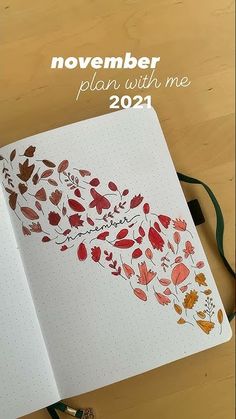 an open notebook with leaves on it and the words november plan with me next to it