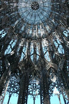 an intricate metal structure is shown in the sky