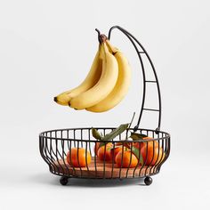 bananas and oranges are in a wire basket