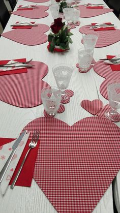 the table is set with red and white hearts