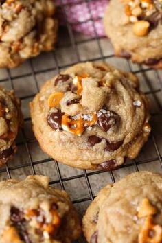 chocolate chip cookies on a cooling rack with orange peels and chopped walnuts in the middle