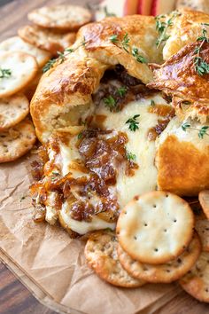 an assortment of appetizers and crackers on a piece of wax paper