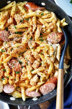 a skillet filled with pasta and sausage