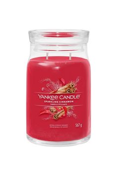 yankee candle with pomegranate and cinnamon in a glass jar on a white background