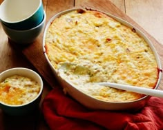 a casserole dish and two cups on a wooden table