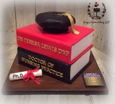 a cake made to look like books with a graduation cap on top and the words dr teresa lewis dnp