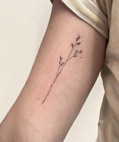 a small flower tattoo on the arm