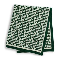 two green and white knitted napkins on top of each other, one with an arrow