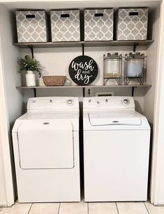 a washer and dryer sitting in a room next to each other with baskets on the wall