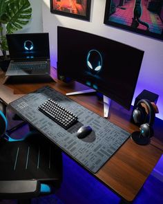 a computer desk with two monitors and a keyboard on top of it, along with headphones