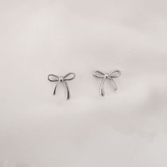 Dainty Coquette Ribbon Earrings - This listing is for the Dainty Coquette Ribbon Earring(s)- Base Material: High Quality Stainless Steel- Finish: 18K Gold or Stainless Steel - Measurements: Width - 15mm, Length Left - 11mm, Length Right - 15mm- Nickel Free- All our jewelry is packaged in gift ready boxes. If you would like multiple items from your order packaged separately please let us know!© 2024 Generation of Daughters Coquette Earing, Ribbon Earring, Coquette Gifts, Coquette Earrings, Girly Earrings, Dainty Coquette