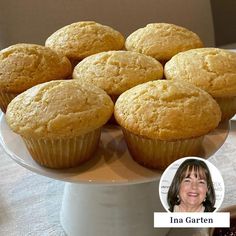 several muffins on a cake stand next to some condiments