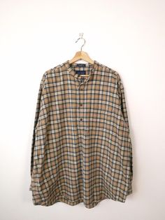 Vintage Beige/Navy Blue Plaid Collarless Flannel Pullover/Shirt. Measurements Length: 34" Armpit to armpit: 28 1/2" Armpit to end of sleeve: 20 1/2" Condition: Gently used. There's no stains or holes. Good condition. ※Please read the policy before you purchase※ Plaid Long Sleeve Shirt For Daywear, Long Sleeve Plaid Tops For Daywear, Oversized Plaid Top For Daywear, Classic Plaid Tops For Daywear, Classic Long Sleeve Plaid Tops, Collared Plaid Tops For Daywear, Plaid Collared Top For Daywear, Beige Plaid, Pullover Shirt