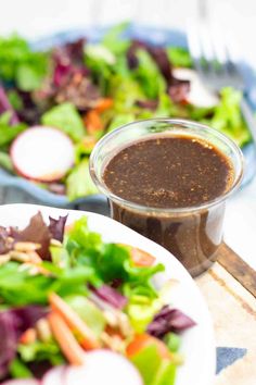 two plates with salad and dressing on them