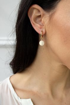 Modern, minimal and fresh! These earrings feature a mini hoop that hugs the earlobe and a genuine mother of pearl coin dangle. They are perfect for everyday wear! Lightweight and comfortable to wear. Materials: 14K gold filled or sterling silver Earring: 14k gold filled or sterling silver hoop with secure latch hook Measures: 1" in length Handmade in New York Arrives perfectly packaged, ready for gift-giving! Christine Elizabeth, Affordable Fine Jewelry, Bridesmaid Pearl Earrings, Elizabeth Jewelry, Gemstone Hoop Earrings, Dainty Hoop Earrings, Pearl Earrings Wedding, Earrings Hoops, Mother Of Pearl Earrings